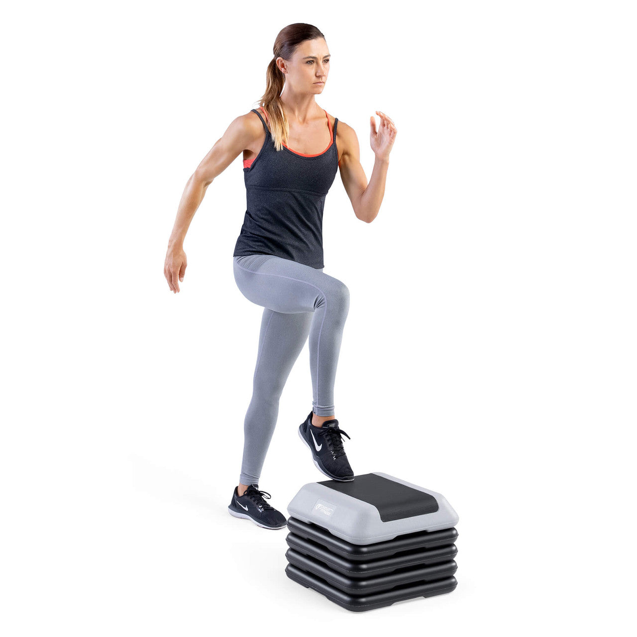 Adjustable Aerobic Step Platform with 4 Risers - Gray - Circuit Fitness model doing step up