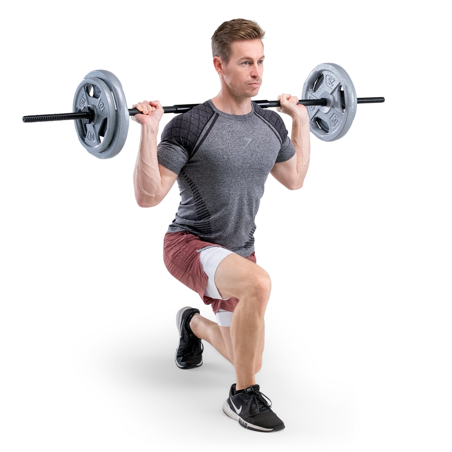 Man performing squats with a barbell on a white background