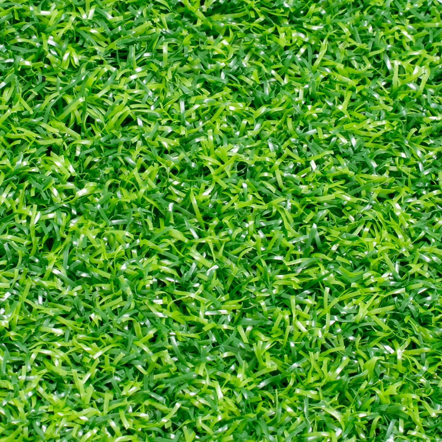 Full-frame top-down view of the green artificial turf texture, showing the density and multi-directional weave of the grass blades.